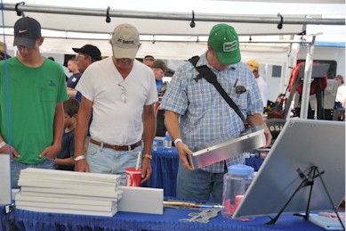 Someone checking out the Billet-TEK valve cover raffle at the parts display